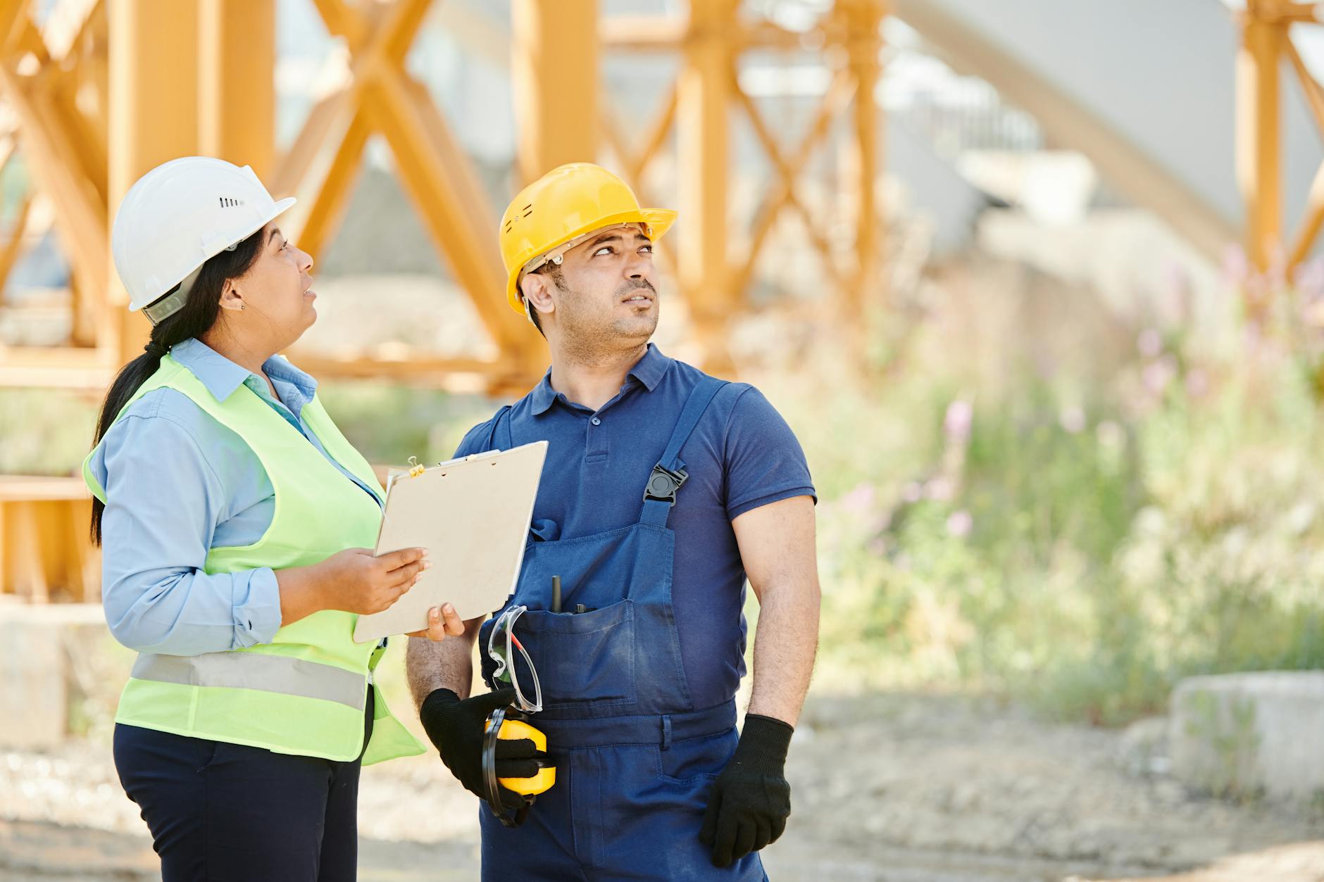 Zwei Fachkräfte besprechen Mängel und Gewährleistung auf der Baustelle im Handwerk